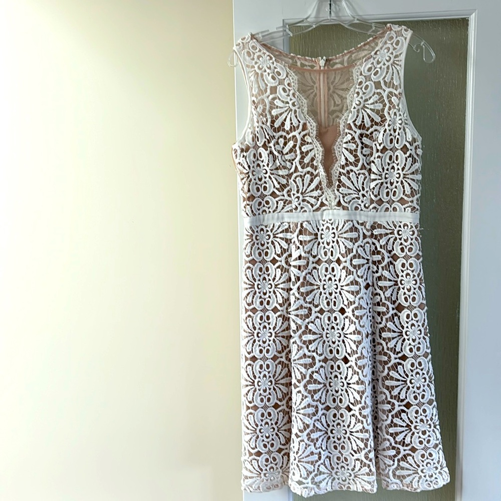 Lace dress with fitted top and flare bottom, white lace with tan underneath.
